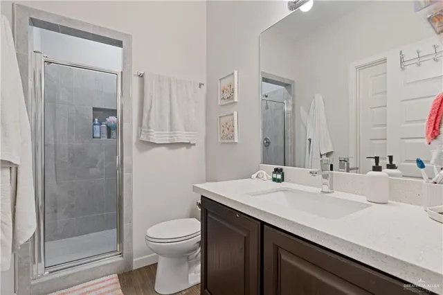 a bathroom with a sink a toilet and shower