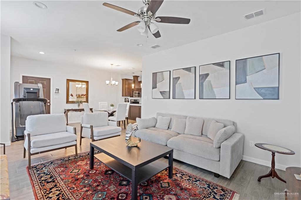 3020 South K Center Street, Unit 2 McAllen, TX 78503 - Photo 3 of 12 a living room with furniture a rug and a chandelier