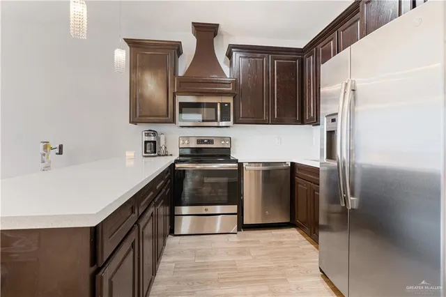 a kitchen with stainless steel appliances a refrigerator and a sink