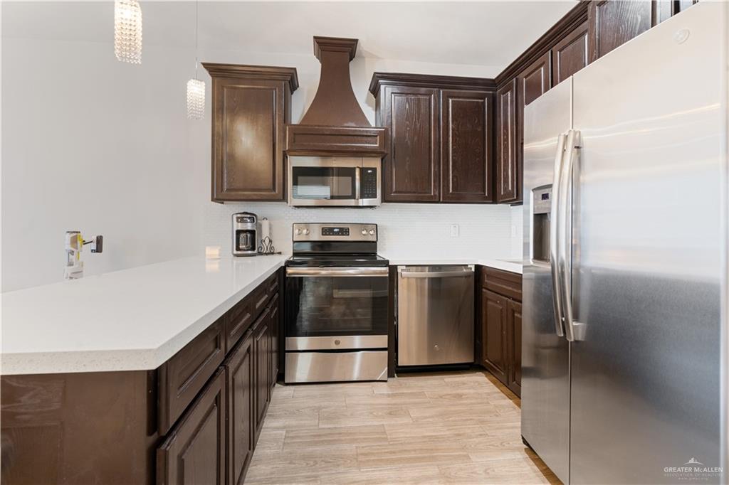3020 South K Center Street, Unit 2 McAllen, TX 78503 - Photo 5 of 12 a kitchen with stainless steel appliances a refrigerator and a sink