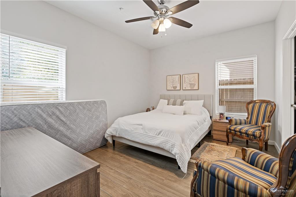 3020 South K Center Street, Unit 2 McAllen, TX 78503 - Photo 6 of 12 a bedroom with a bed and a chandelier