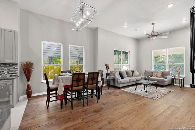 a living room with furniture dining table and a large window