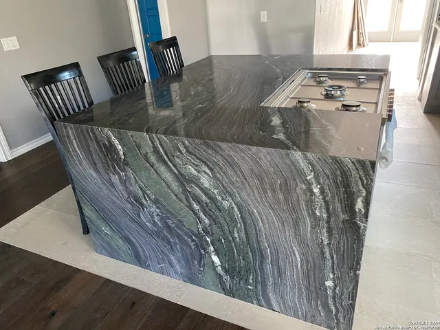 a kitchen with a stove and a chandelier