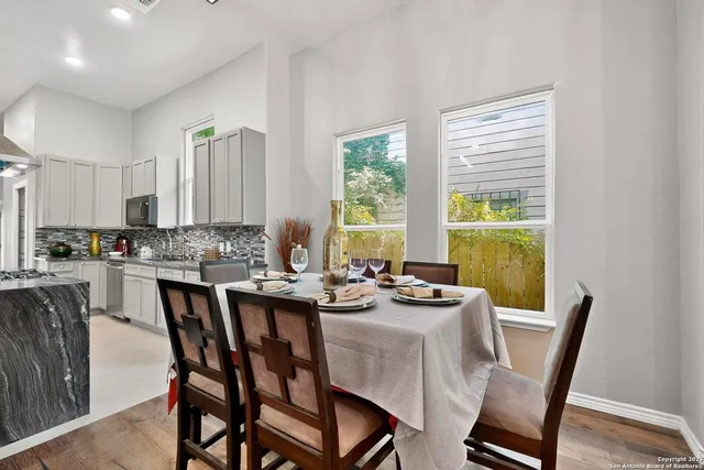 a view of a dining room with furniture chandelier and wooden floor