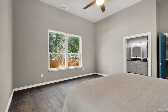 a bed sitting in a bedroom next to a window