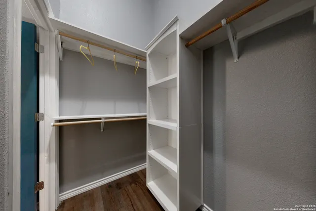 a bathroom with a granite countertop toilet sink and mirror