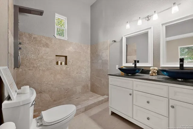 a bathroom with a double vanity sink and mirror