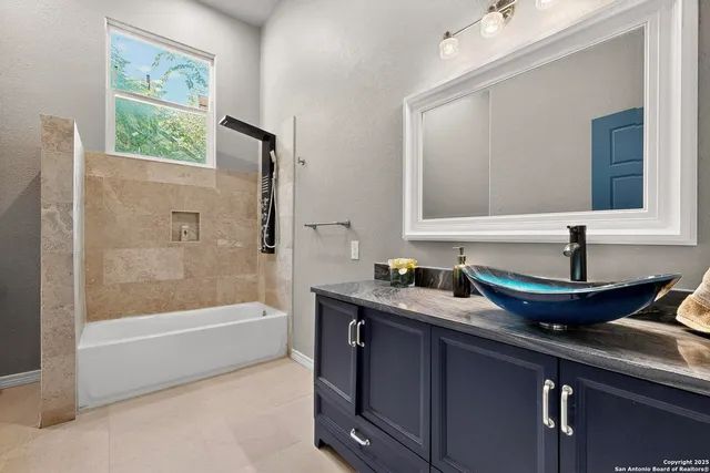 a white bath tub sitting next to a toilet