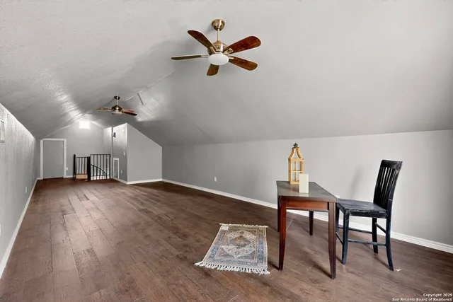 a view of a workspace with wooden floor and a window