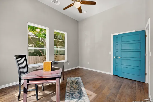 a workspace with wooden floor and a window
