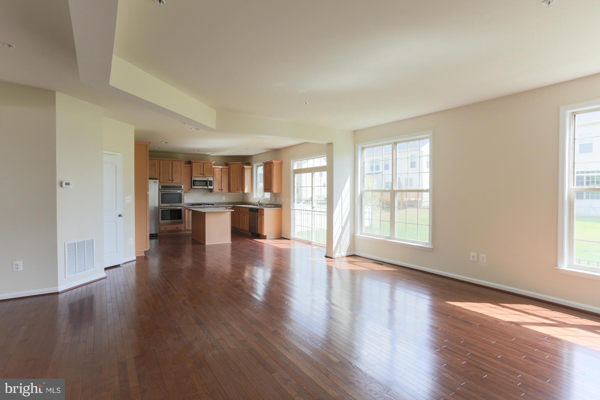 9404 Cross Road Perry Hall, MD 21128 - Photo 12 of 30 an empty room with wooden floor and windows