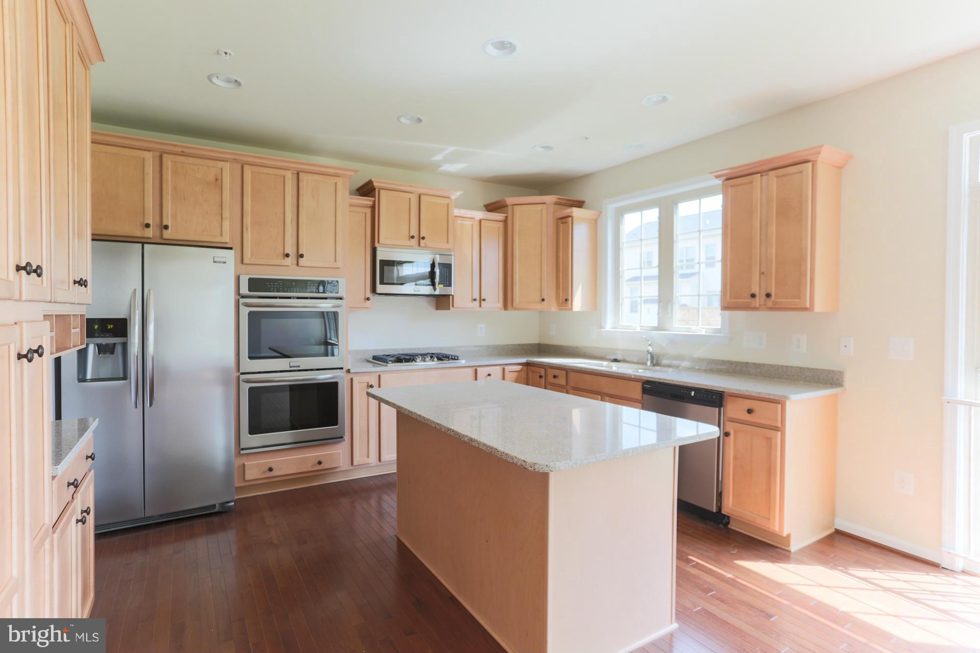 9404 Cross Road Perry Hall, MD 21128 - Photo 14 of 30 a kitchen with stainless steel appliances granite countertop a stove a sink and a refrigerator