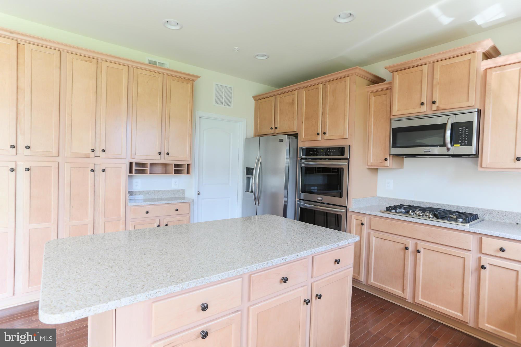 9404 Cross Road Perry Hall, MD 21128 - Photo 16 of 30 a kitchen with stainless steel appliances granite countertop a refrigerator and cabinets