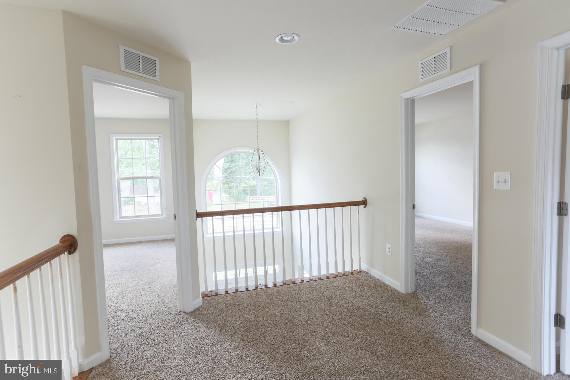 9404 Cross Road Perry Hall, MD 21128 - Photo 18 of 30 a view of a hallway to room with wooden floor
