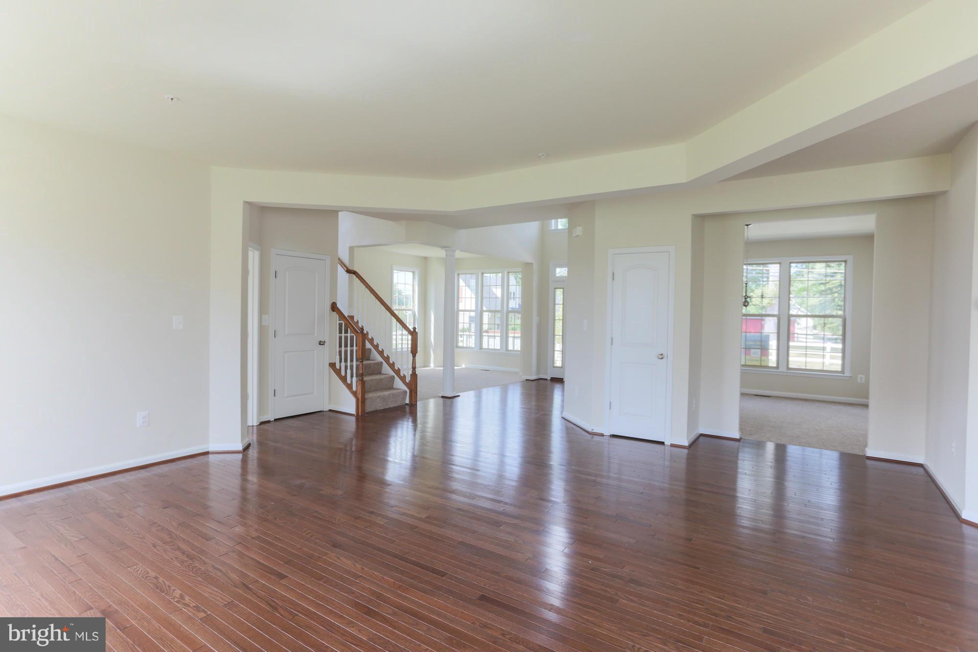 9404 Cross Road Perry Hall, MD 21128 - Photo 10 of 30 a view of an empty room with wooden floor and a window