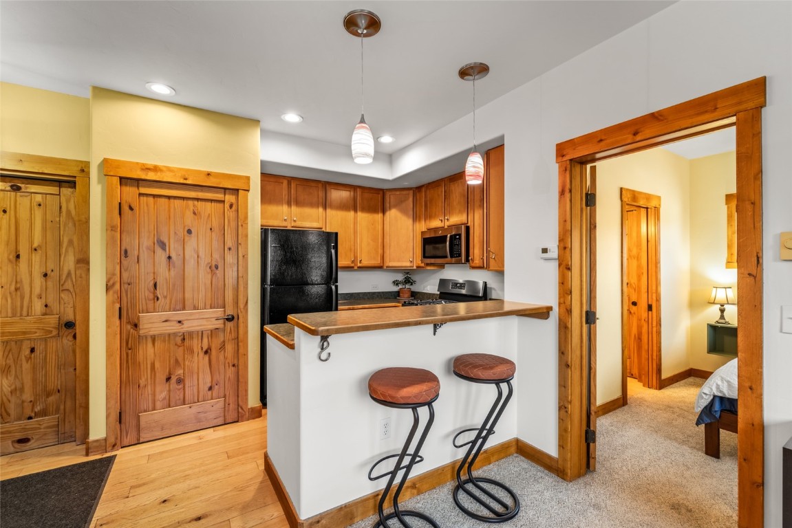 35 11th Street, Unit B Steamboat Springs, CO 80487 - Photo 6 of 18 a kitchen with stainless steel appliances granite countertop a refrigerator and a stove