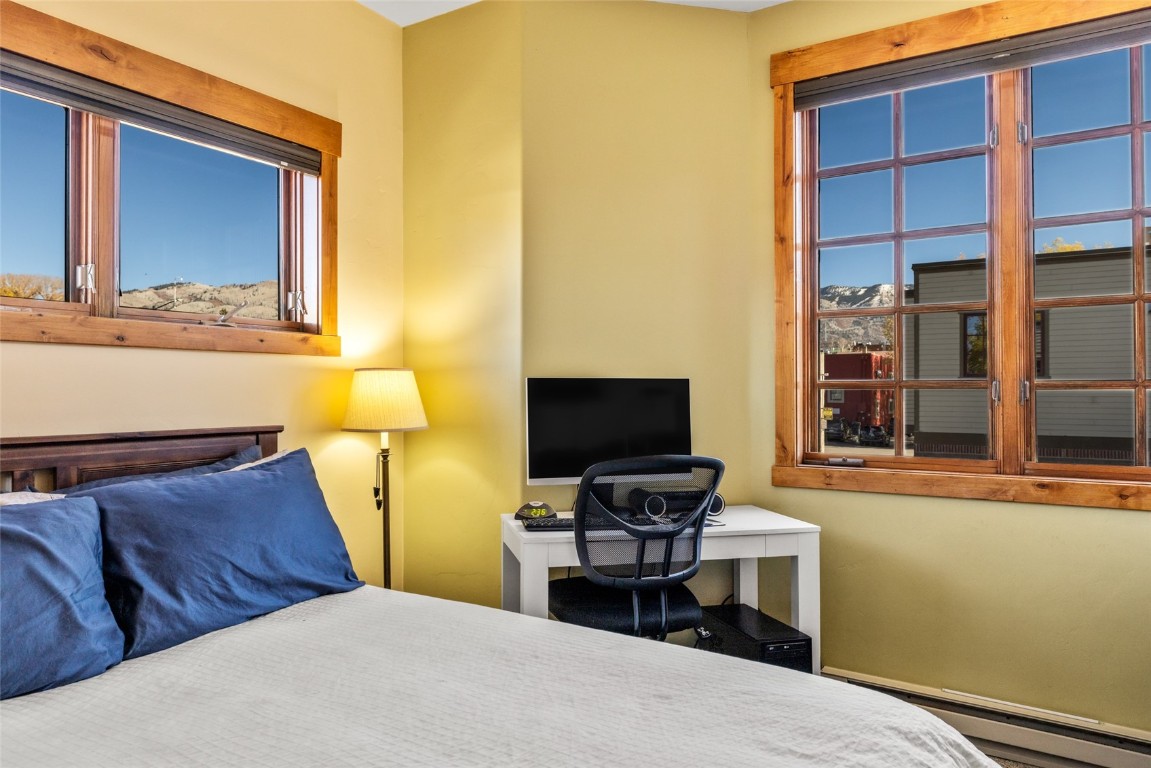 35 11th Street, Unit B Steamboat Springs, CO 80487 - Photo 9 of 18 a bedroom with a bed and wooden floor