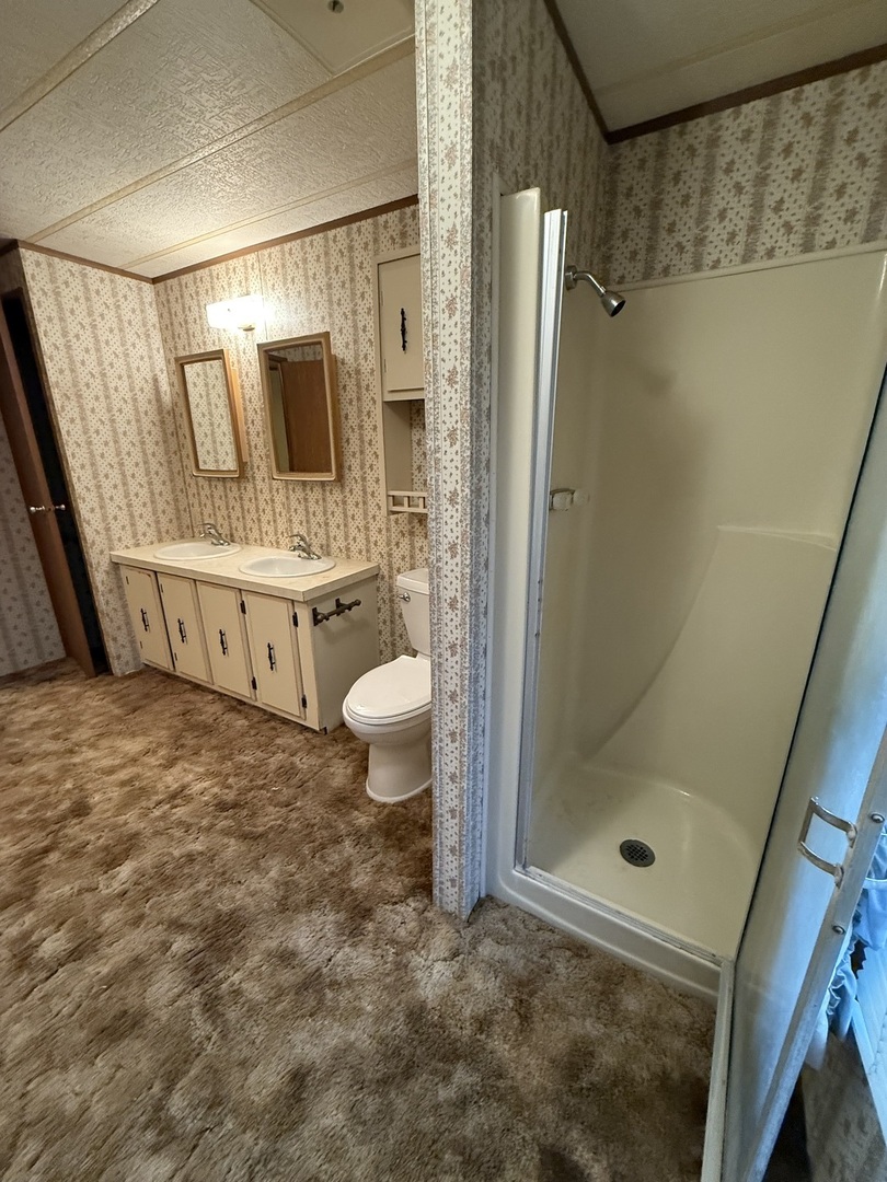 602 Tanglewood Road Matteson, IL 60443 - Photo 16 of 26 a bathroom with a granite countertop sink a mirror and shower