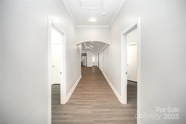 a view of a hallway with wooden floor