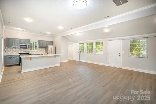 a view of kitchen with wooden floor and windows