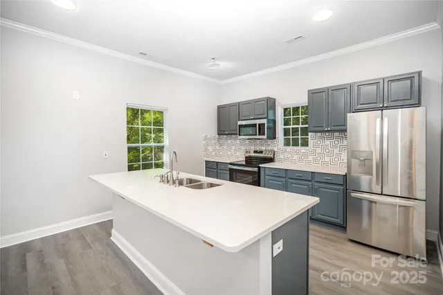 a kitchen with a refrigerator a stove a sink and a refrigerator