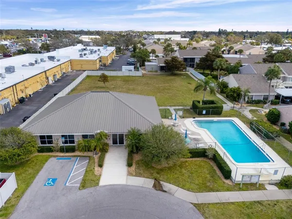 an aerial view of a house with a swimming pool yard and outdoor seating