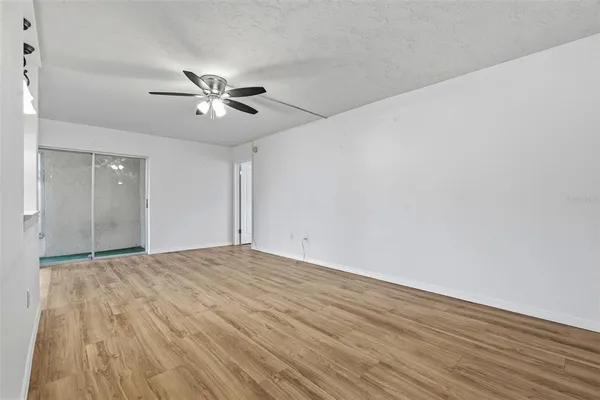a view of empty room with wooden floor