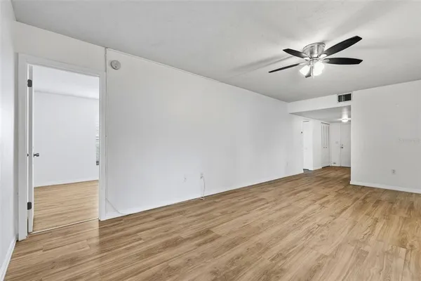 a view of empty room with wooden floor