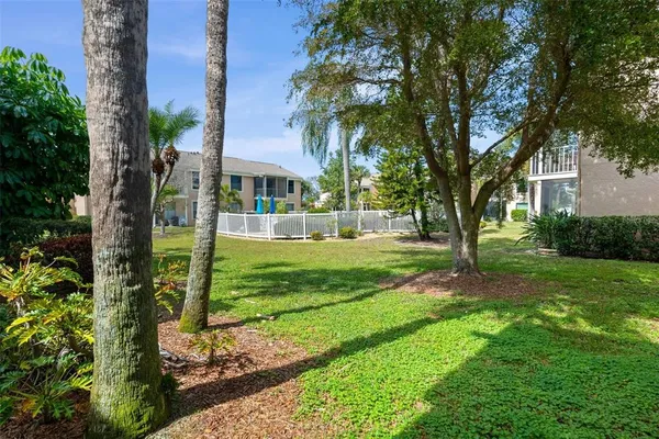 a view of a yard in front of house with a tree