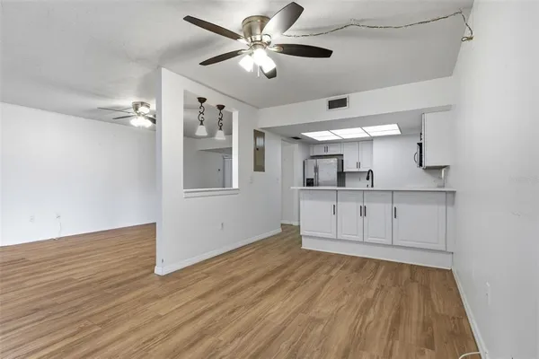 a view of a kitchen with wooden cabinet and a ceiling fan