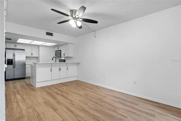 a view of a kitchen with a sink and a refrigerator