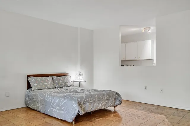 a bedroom with a bed and night stand
