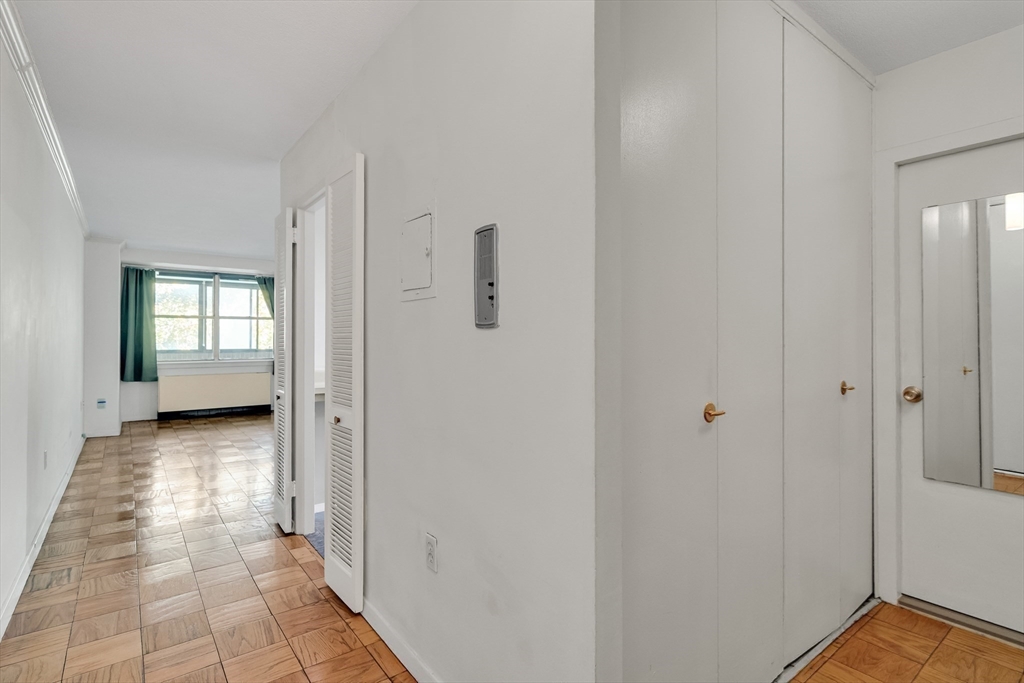 9 Hawthorne Place, Unit 5K Boston, MA 02114 - Photo 19 of 37 a view of a hallway with bathroom and wooden floor