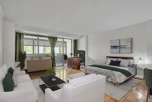 a bedroom with a bed and glass window