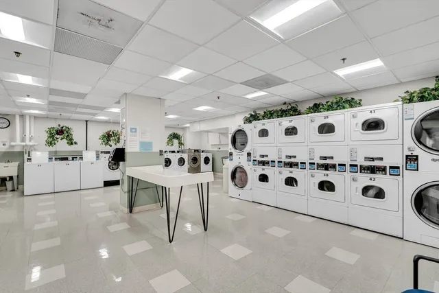 a kitchen with a stove a table and chairs in it