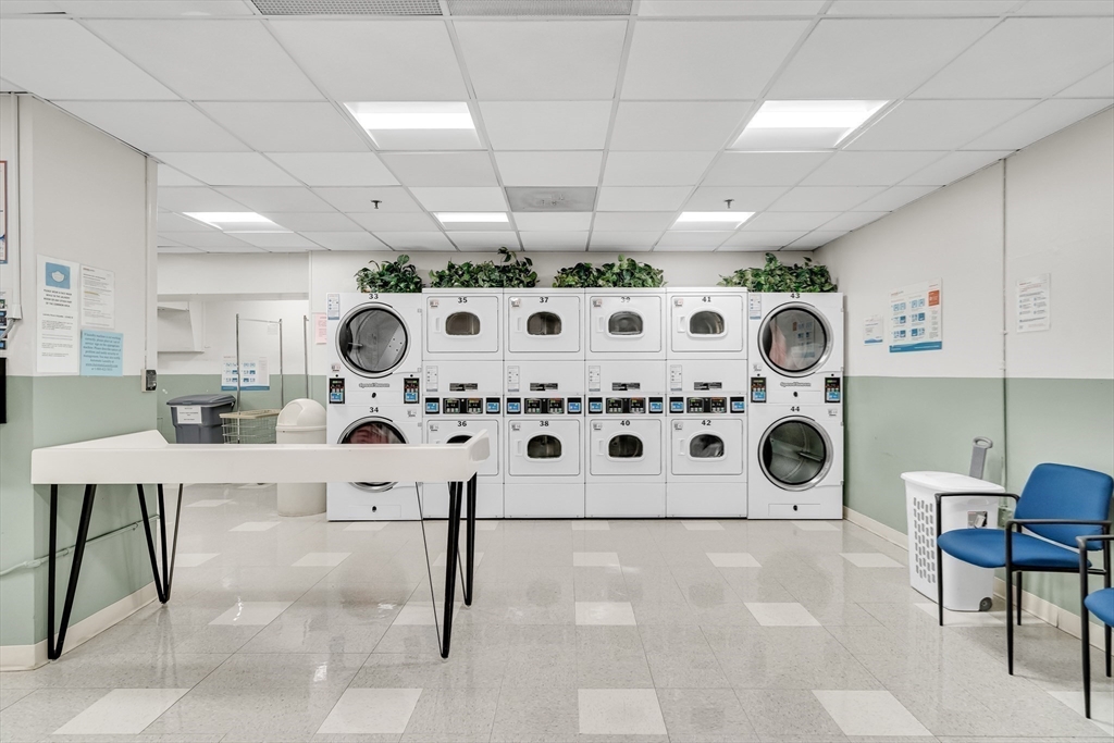 9 Hawthorne Place, Unit 5K Boston, MA 02114 - Photo 27 of 37 a kitchen with a stove a table and chairs in it