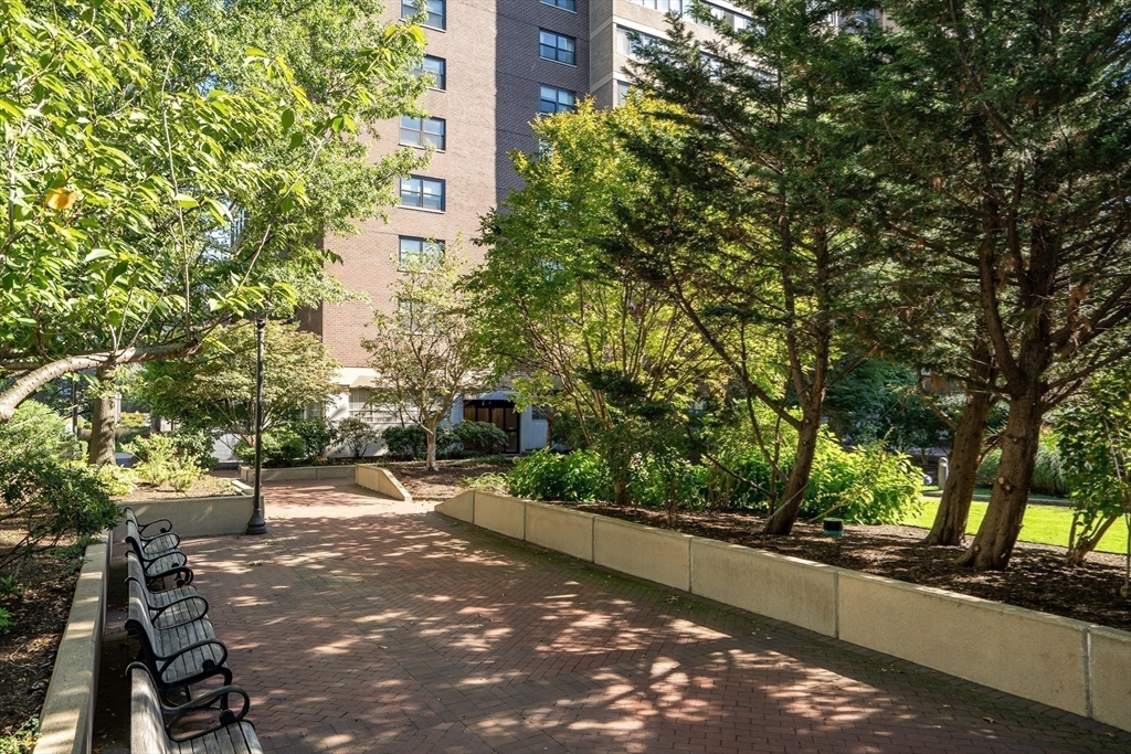 9 Hawthorne Place, Unit 5K Boston, MA 02114 - Photo 32 of 37 a view of a patio with table and chairs and potted plants