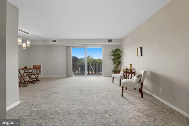 a view of a livingroom with furniture and a window