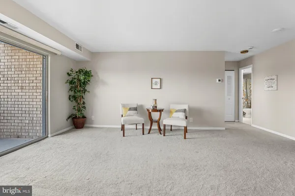 a view of a livingroom with furniture and a window