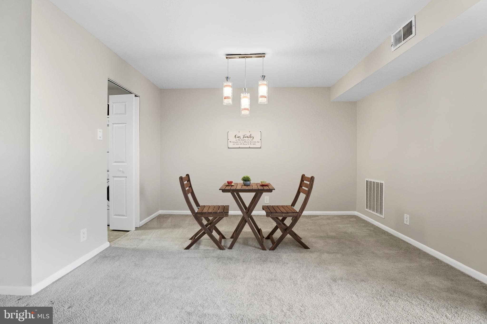 12001 Old Columbia Pike, Unit 508 Silver Spring, MD 20904 - Photo 6 of 22 a view of a dining room with furniture and chandelier