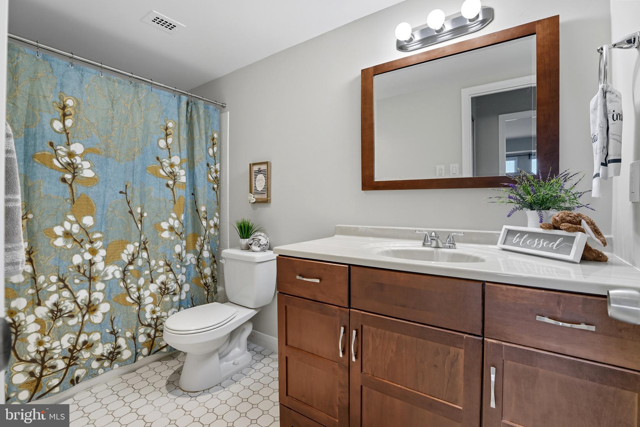 12001 Old Columbia Pike, Unit 508 Silver Spring, MD 20904 - Photo 10 of 22 a bathroom with a toilet sink and mirror