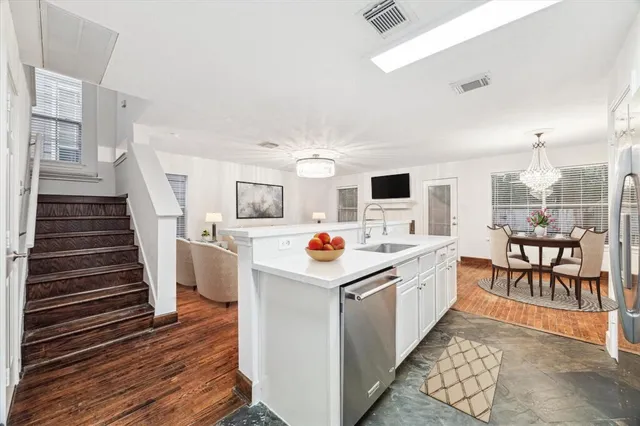 a kitchen that has a microwave and a table in it
