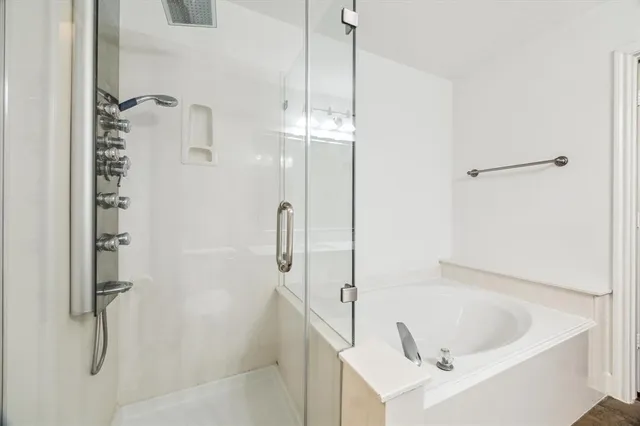 a bathroom with a bathtub and shower