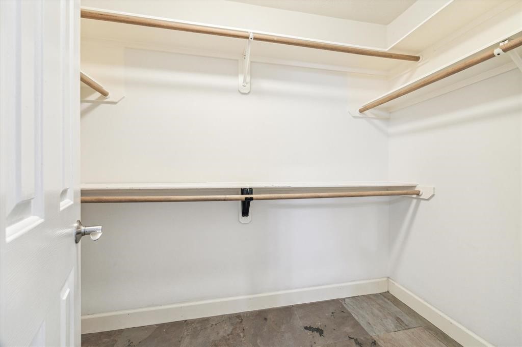 227 Blushwood Place Spring, TX 77382 - Photo 23 of 30 Generously sized walk-in closet featuring built-in shelving and dual hanging space—designed for effortless organization.