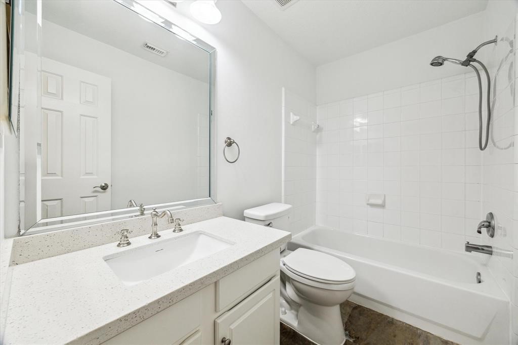 227 Blushwood Place Spring, TX 77382 - Photo 26 of 30
Bright and clean full secondary bathroom with quartz vanity, oversized mirror, and a tiled shower/tub combo—simple and stylish for everyday comfort.