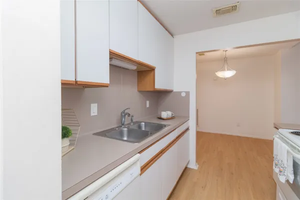 a kitchen with a sink and cabinets