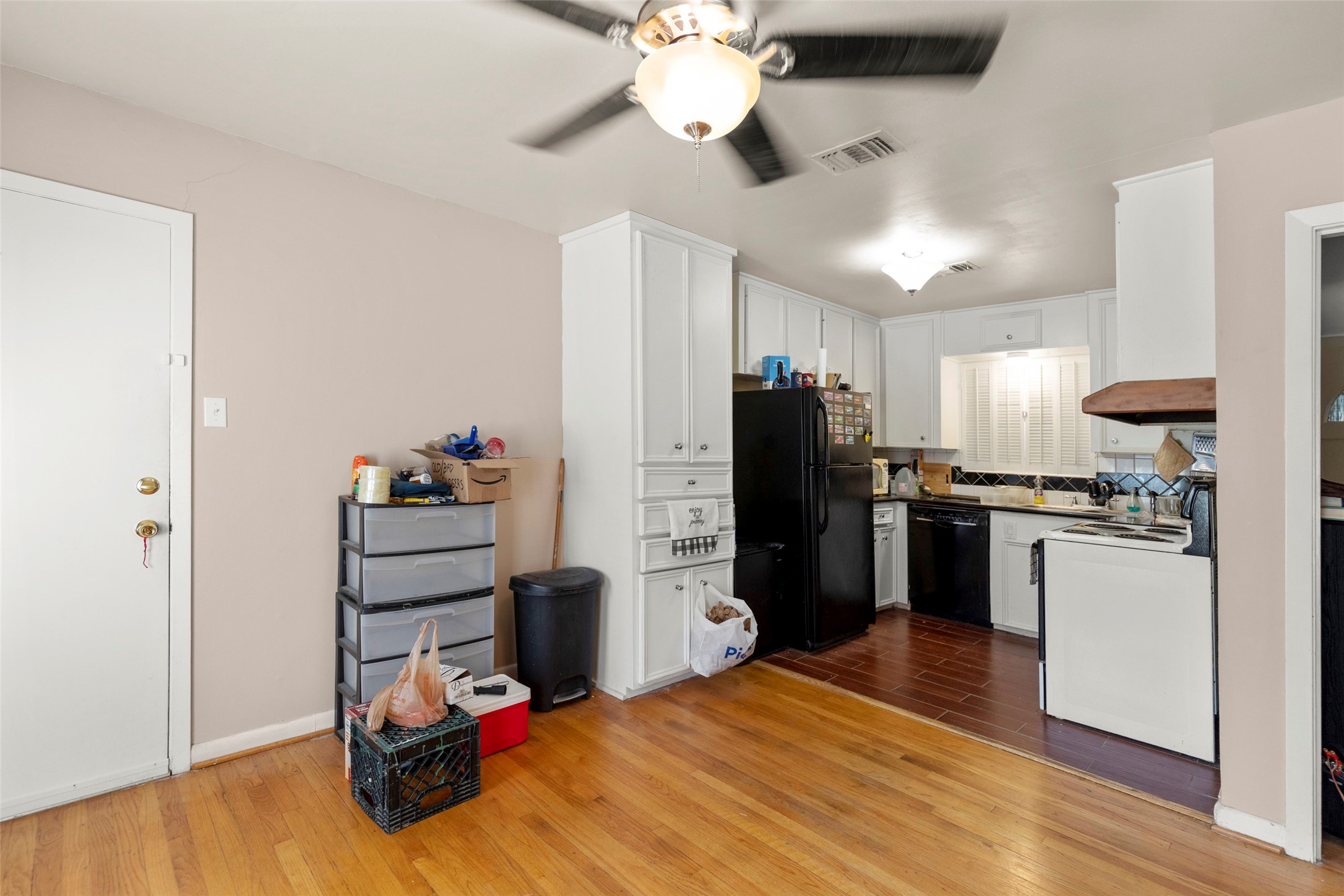 4709 Sanford Road Houston, TX 77035 - Photo 7 of 19 a kitchen with stainless steel appliances kitchen island granite countertop a refrigerator cabinets and wooden floor