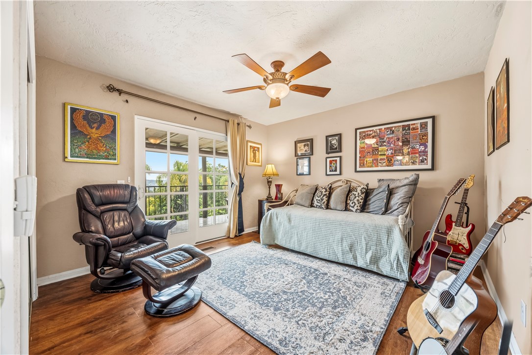 1485 Vía Ladera Fallbrook, CA 92028 - Photo 20 of 43 a living room with furniture rug and wooden floor
