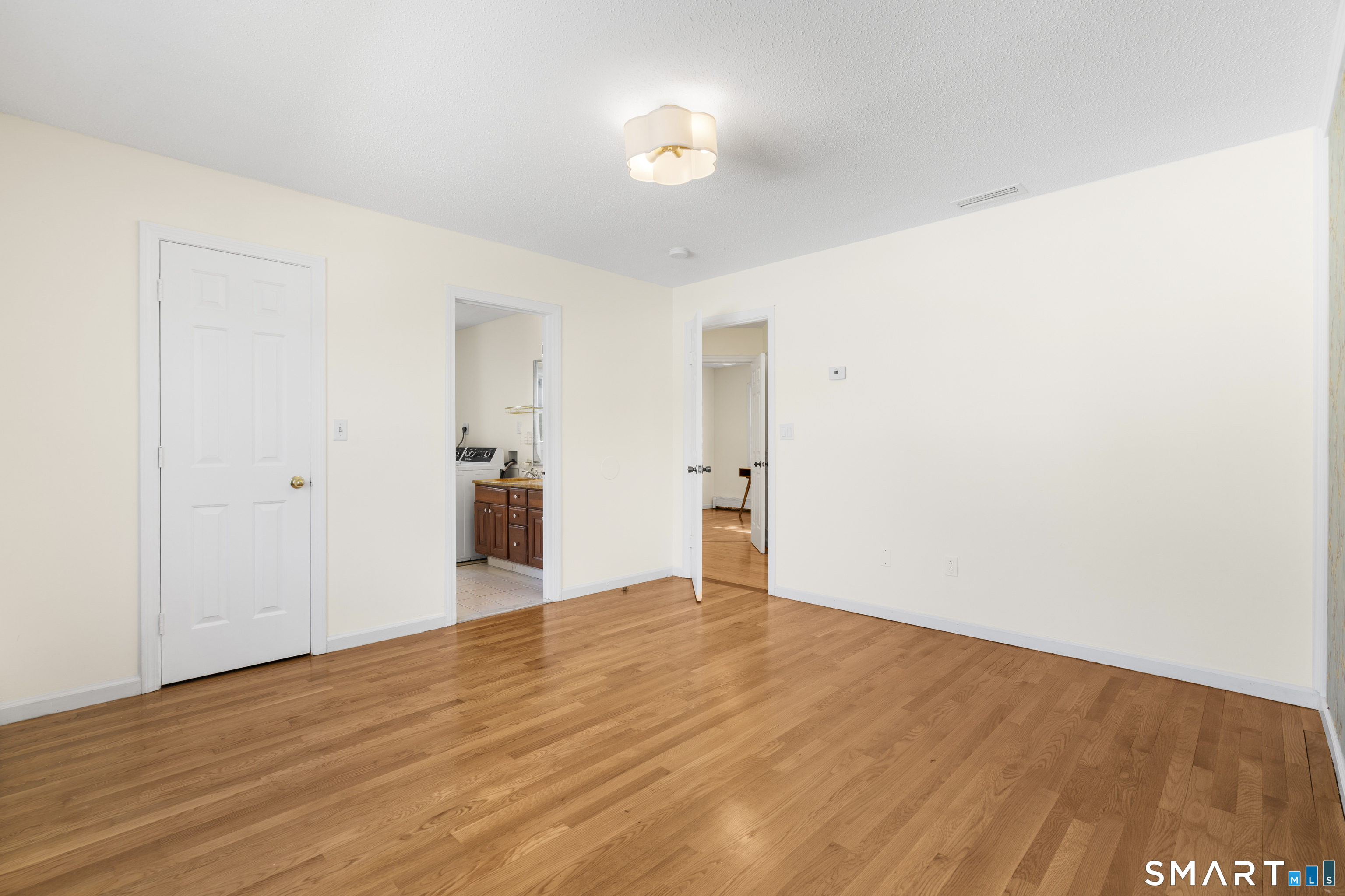 39 Joseph Lane Hamden, CT 06514 - Photo 21 of 40 a view of empty room with wooden floor and window