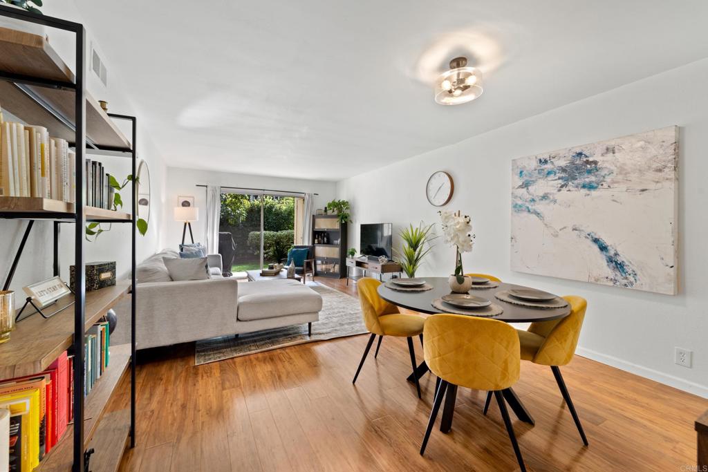 760 Encinitas Boulevard, Unit 101 Encinitas, CA 92024 - Photo 1 of 1 a view of a dining room with furniture wooden floor and a chandelier